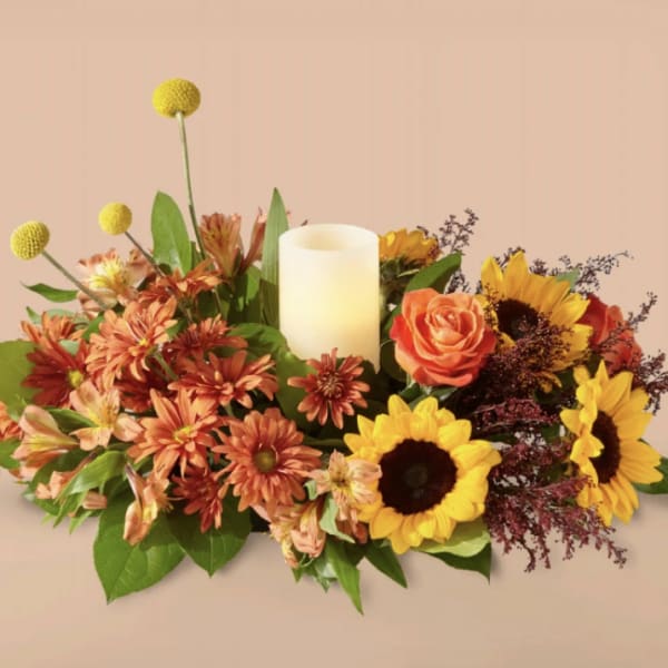 Autumn floral centerpiece with a candle and sunflowers