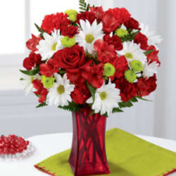 Red and white flower bouquet in a red vase