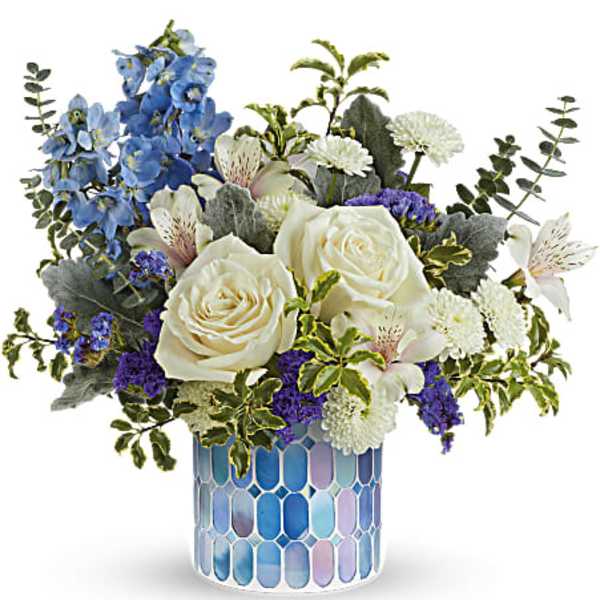 Blue and white floral arrangement in a mosaic glass vase