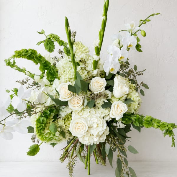 White and green wedding bouquet with roses, orchids, and hydrangeas