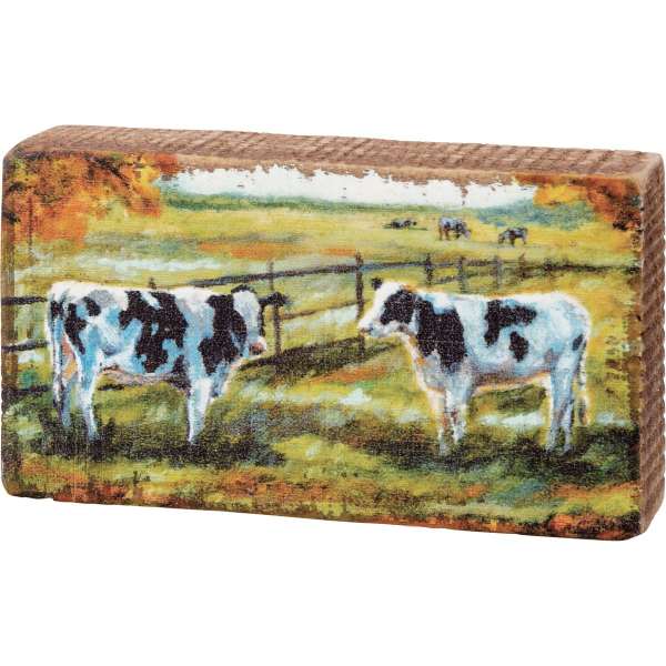 Rectangular decorative block with a painted cow scene