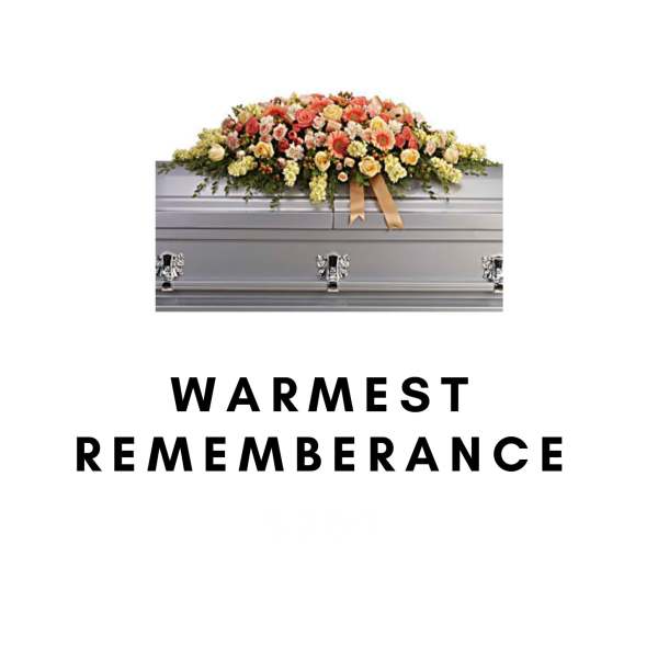 Flower-covered silver casket with a warm-toned spray