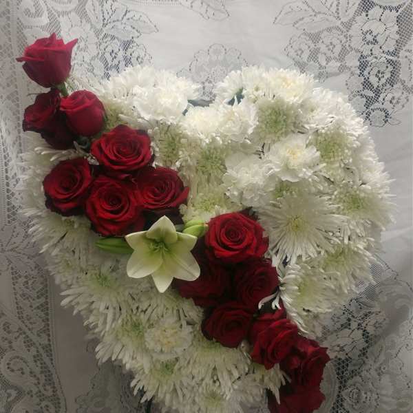 Heart-shaped bouquet of red roses and white chrysanthemums