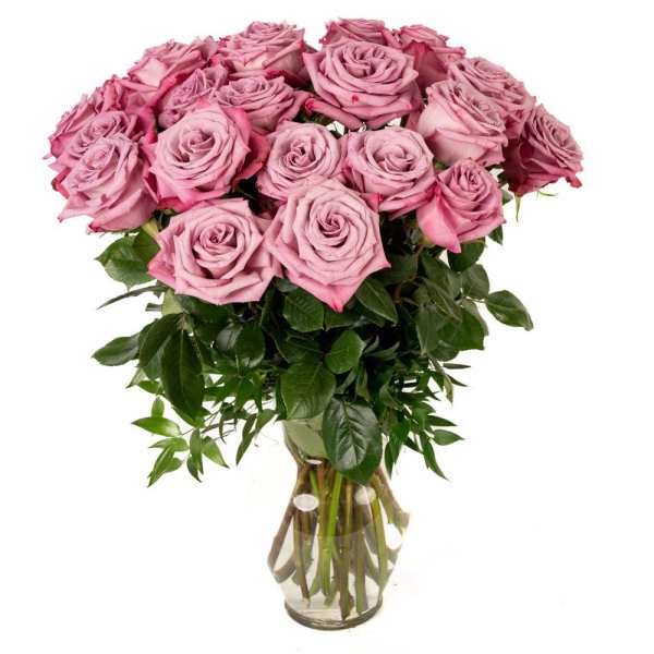 Tall arrangement of mauve pink roses in a clear glass vase