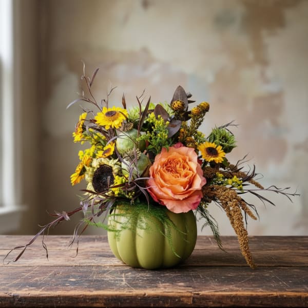 Pumpkin-shaped vase with orange rose and yellow flowers
