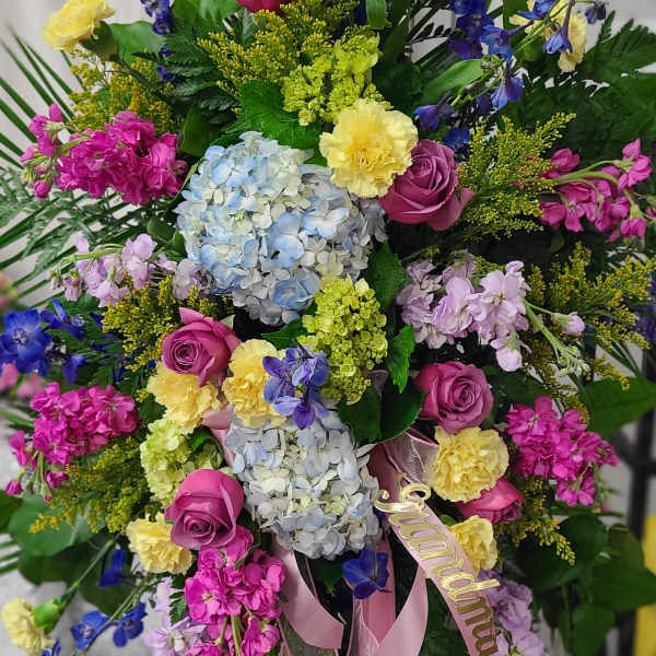 Colorful bouquet with hydrangeas, roses, and blue delphinium