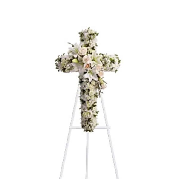 White floral cross arrangement on a standing easel