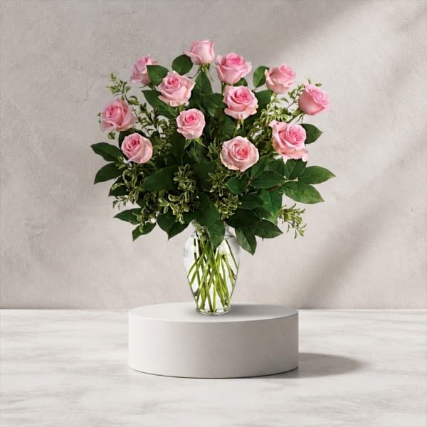 Pink roses arranged in a clear glass vase