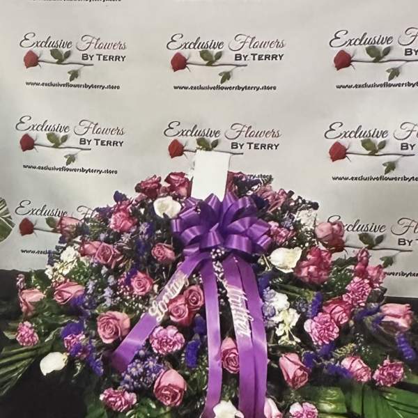 Large purple and pink floral spray with a ribbon bow
