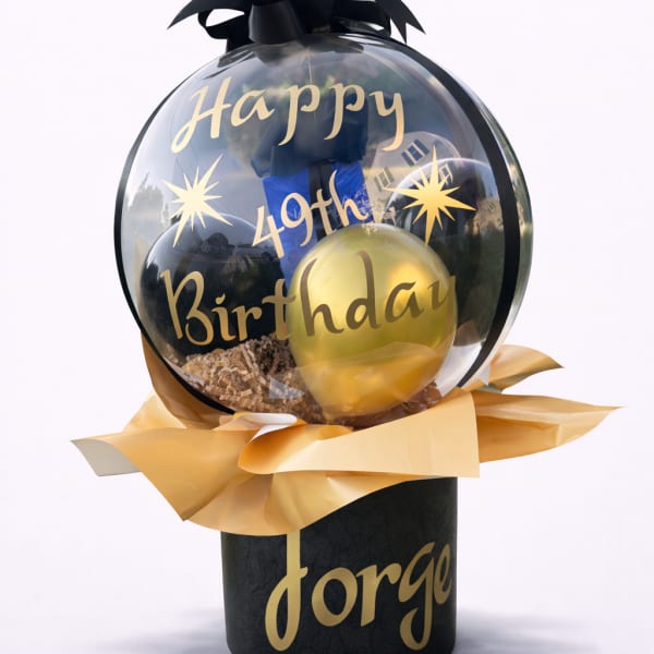 Birthday balloon gift with black and gold balloons in a clear dome