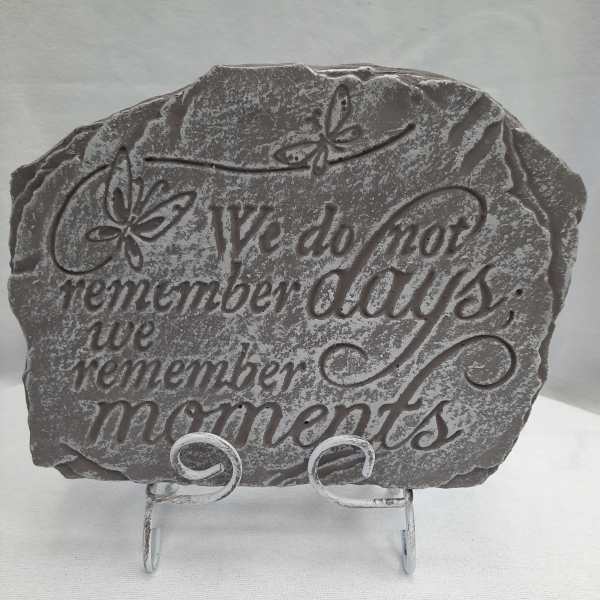 Gray memorial plaque on a metal stand with butterfly accents