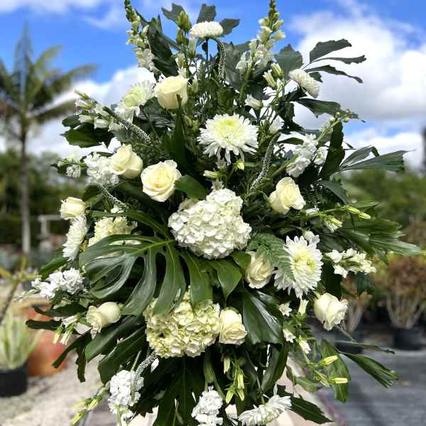 Large white floral standing spray with roses and chrysanthemums