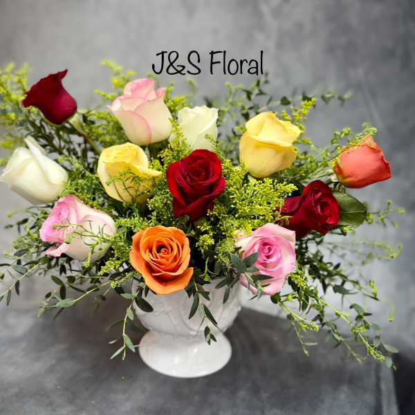 Mixed roses in a white pedestal vase