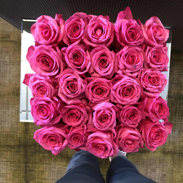 Square box filled with bright pink roses