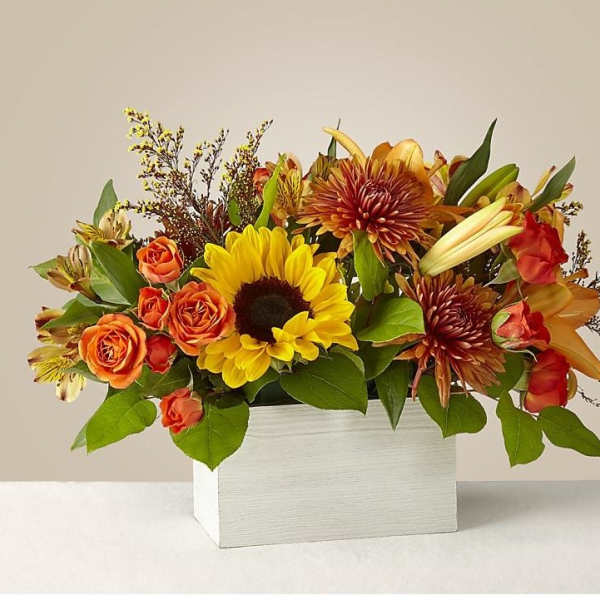 Mixed bouquet of sunflowers, orange roses, and lilies in a white box