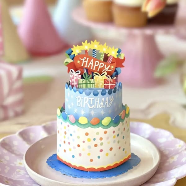 Decorative birthday cake centerpiece with colorful paper toppers