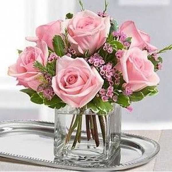 Pink roses arranged in a clear glass vase