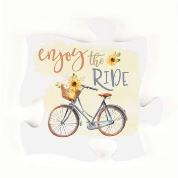 Decorative pillow with a bicycle and sunflower graphic and the words enjoy the ride