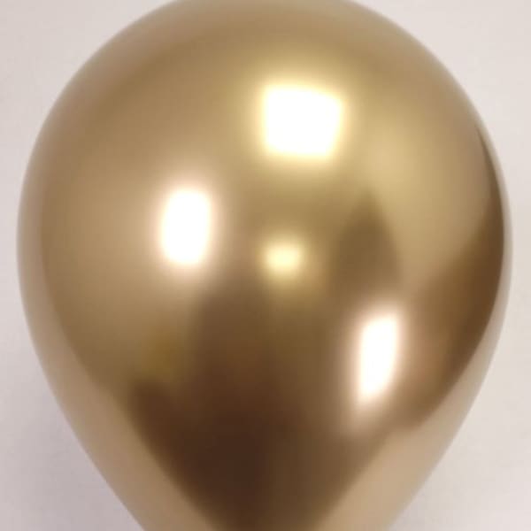 Single metallic gold balloon on a plain background