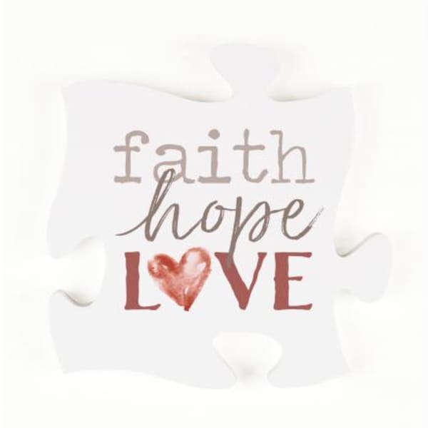 White decorative pillow with the words faith hope love