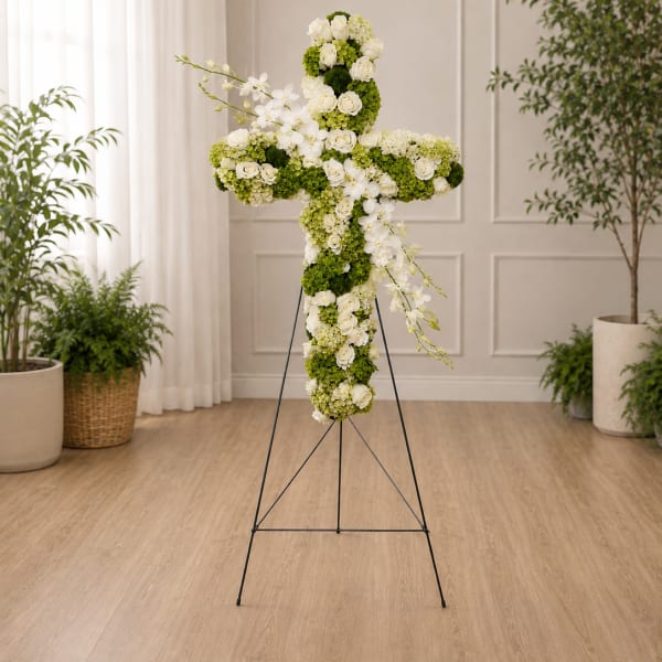 White and green floral cross on a metal stand