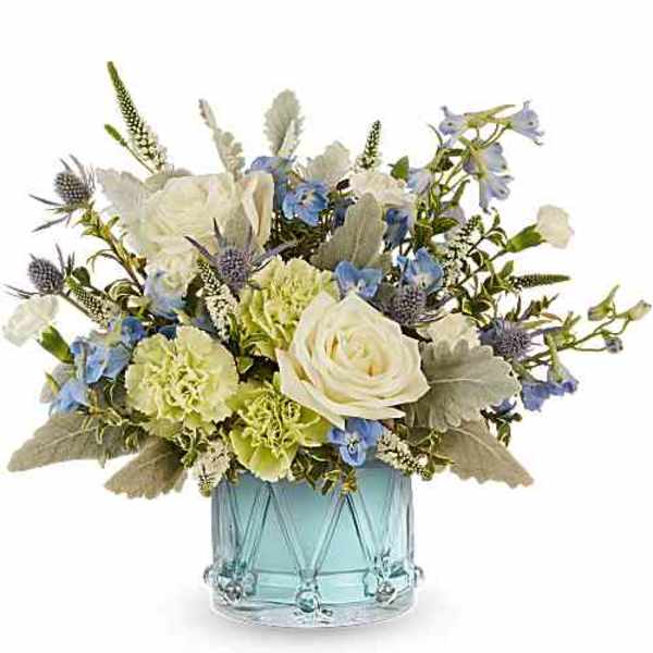 Blue and white floral arrangement in a light blue glass vase