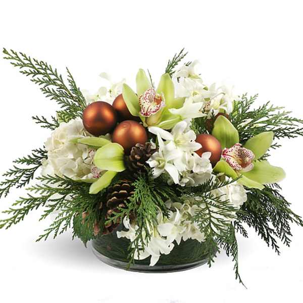White flowers and green orchids in a low glass bowl with pinecones and copper ornaments