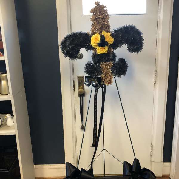 Standing floral cross with yellow roses and black ribbon bows