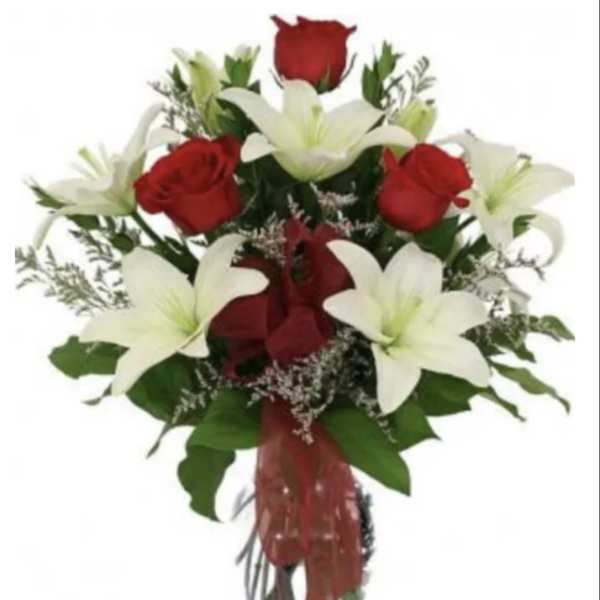 Bouquet of red roses and white lilies in a glass vase