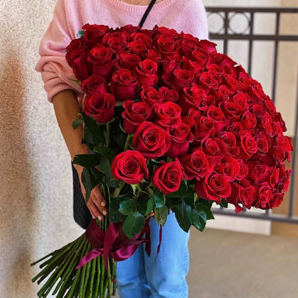 Large bouquet of red roses held by a person