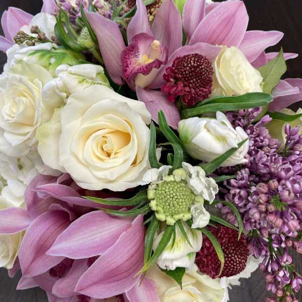 Bouquet of pink lilies, white roses, and purple flowers