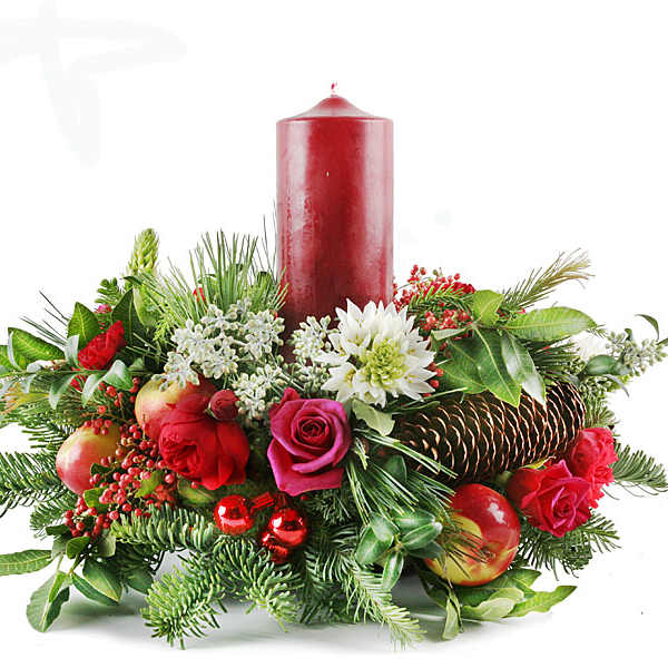 Holiday centerpiece with red candle, roses, and evergreen accents