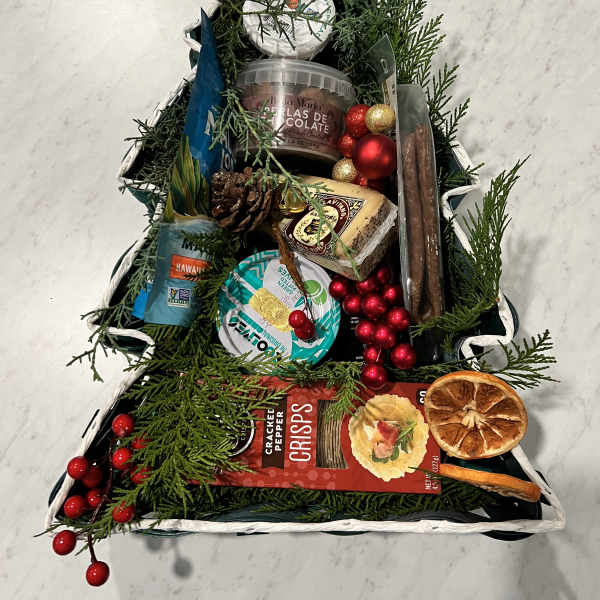 Christmas tree-shaped gift basket with snacks and ornaments