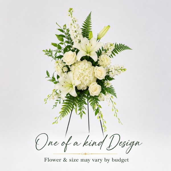 White floral standing arrangement with lilies, roses, and hydrangea