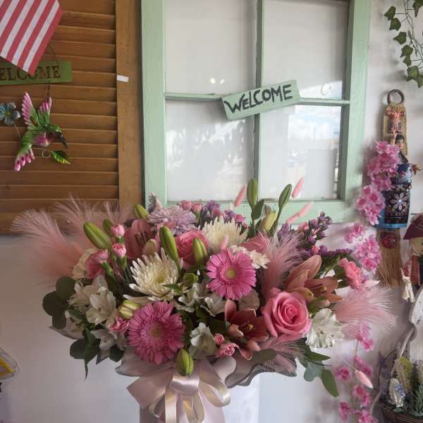 Pink and white mixed bouquet in a round hatbox with ribbon