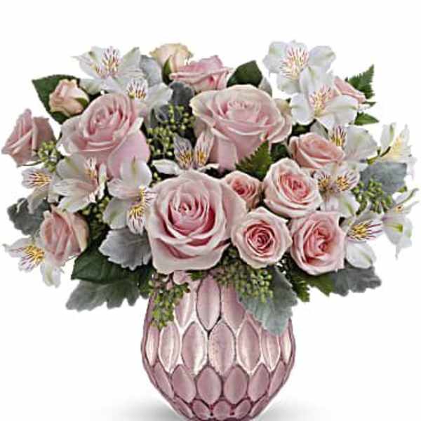 Pink roses and white flowers arranged in a pink vase