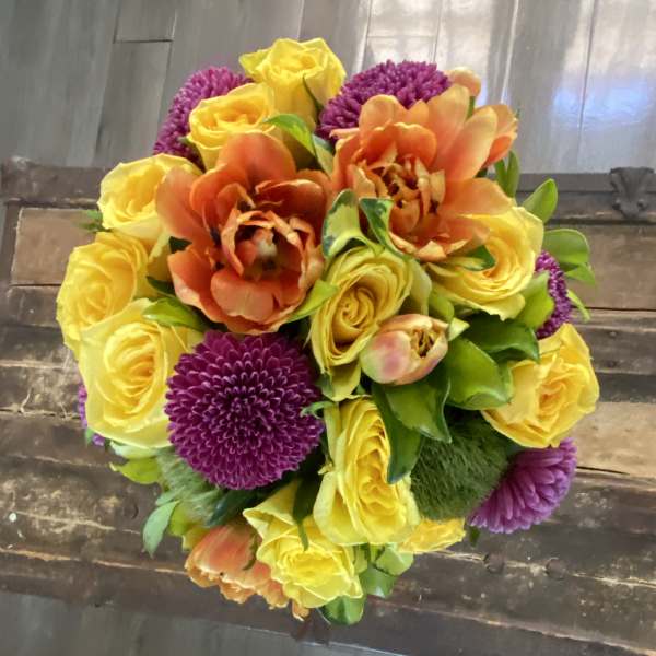 Bouquet of yellow roses, orange tulips, and purple mums