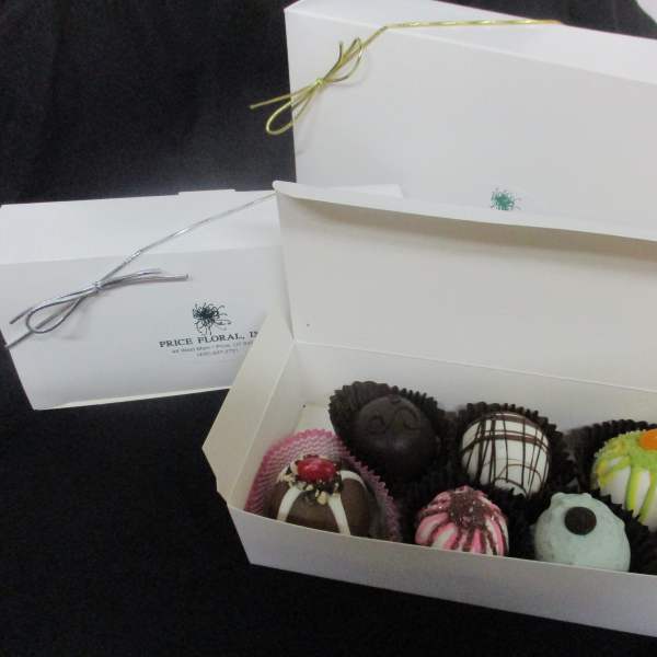 Box of assorted decorated chocolates in white gift boxes