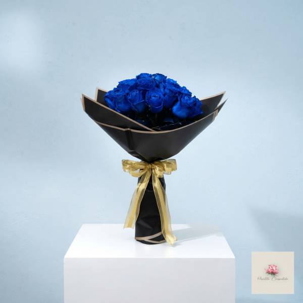 Bouquet of blue roses wrapped in black paper with a gold ribbon