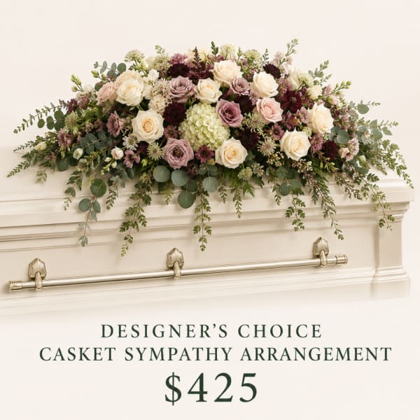 Casket spray with cream, blush, and burgundy flowers