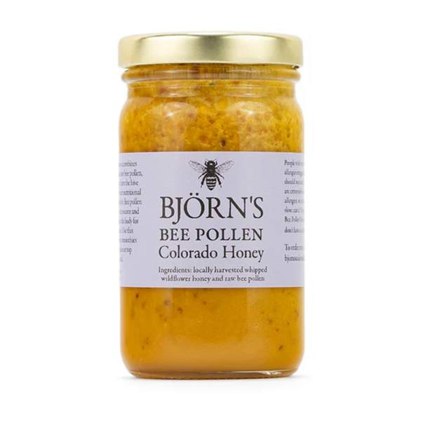Jar of bee pollen honey with a gold lid and label
