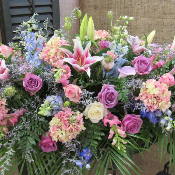 Large mixed floral arrangement with lilies, roses, and hydrangeas