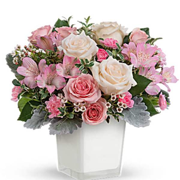 Pink and white roses with alstroemeria in a clear square vase