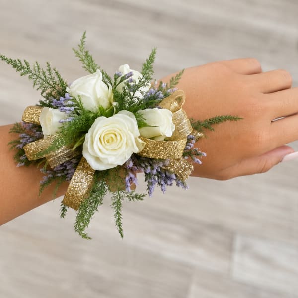 White rose wrist corsage with purple filler and gold ribbon