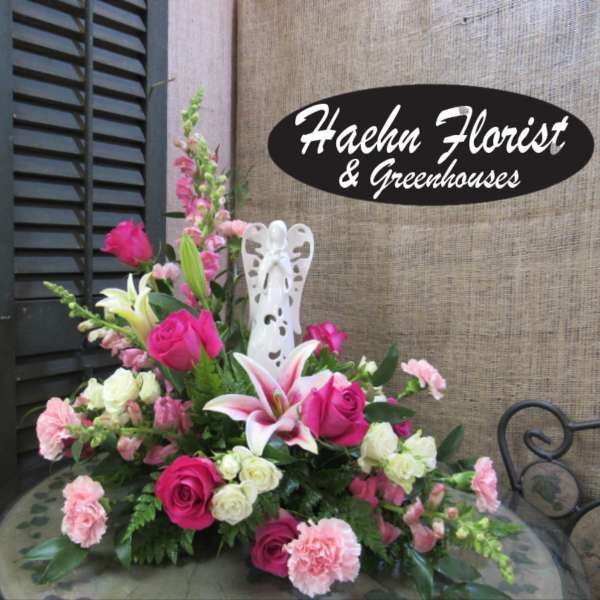 Pink and white floral arrangement with roses, lilies, and carnations
