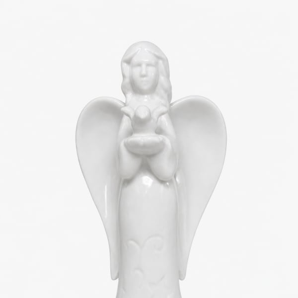 White ceramic angel figurine holding a small bird