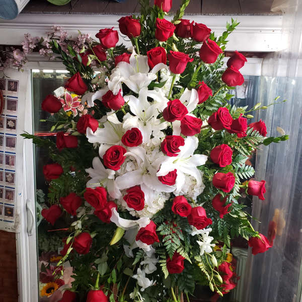 Large standing arrangement of red roses and white lilies