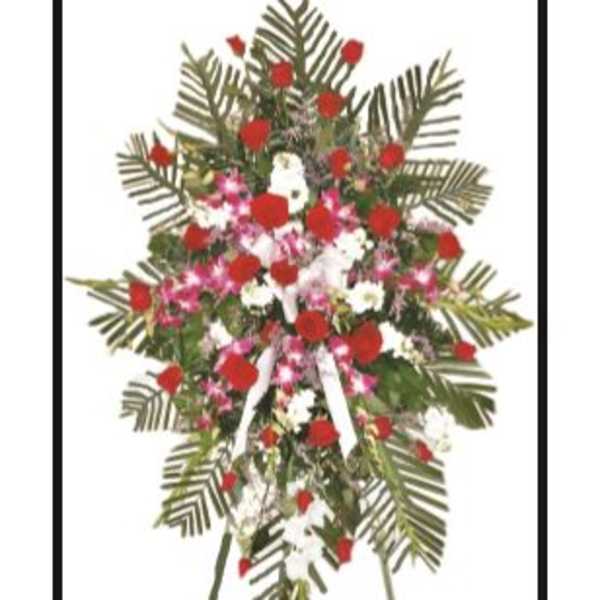 Standing floral spray with red, white, and pink flowers on a tripod easel