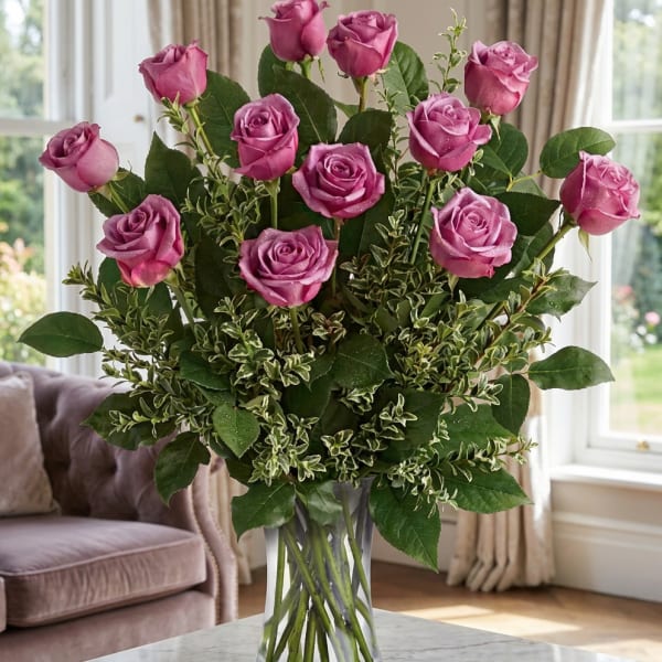 Pink roses arranged in a clear glass vase