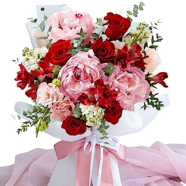 Bouquet of red roses and pink peonies wrapped with pink ribbon